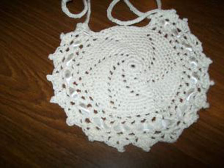 Round crochet cotton bib with lacy edge
